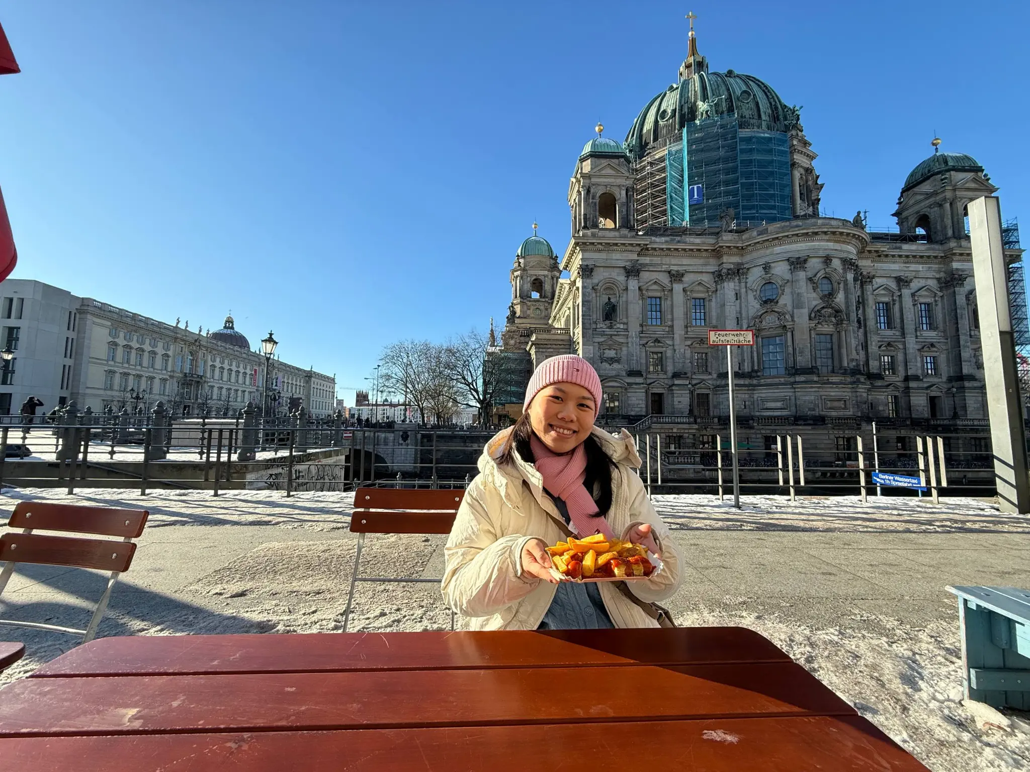 Andralynn at the Berlin Cathedral (Berliner Dom) with currywurst in the snow